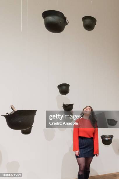 Gallery staff member looks at "Helmets " during a preview of the YOKO ONO: MUSIC OF THE MIND at Tate Modern. © Yoko Ono in London, United Kingdom on...