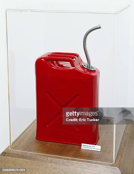 red gasoline can in plastic display case - präsentation hinter glas stock-fotos und bilder