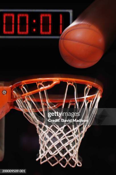 basketball falling into basket (blurred motion) - basketball shot stock pictures, royalty-free photos & images