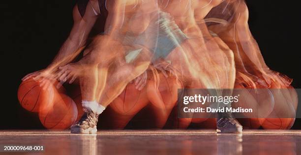 young male basketball player dribbling ball (stroboscopic image) - bouncing fotografías e imágenes de stock