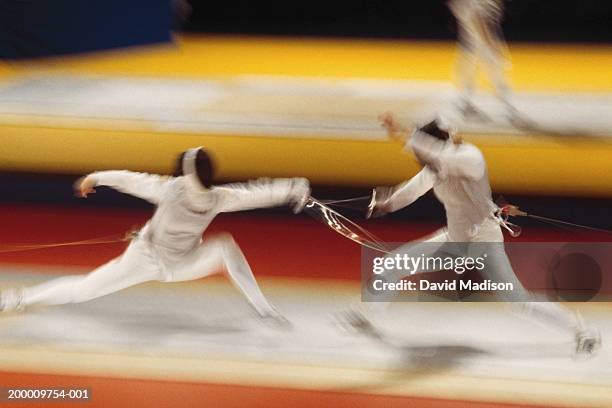 two people fencing (blurred motion) - fäktningsmask bildbanksfoton och bilder