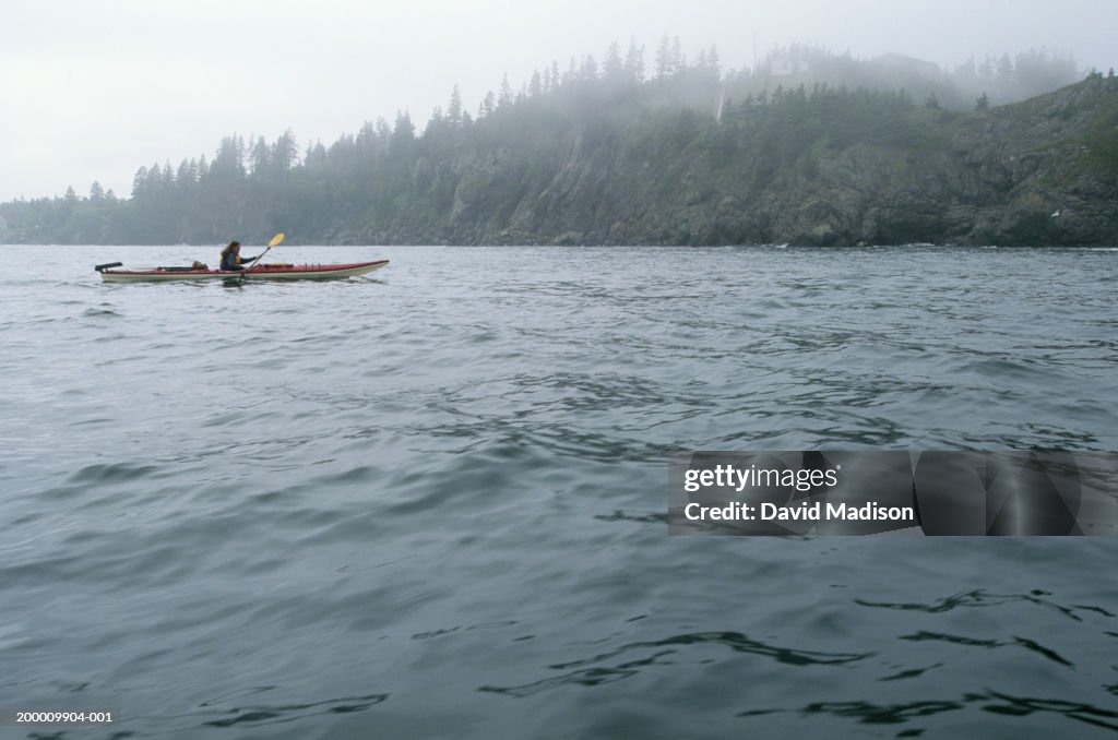 Canada, New Brunswick, Grand Manan Island, woman sea kayaking