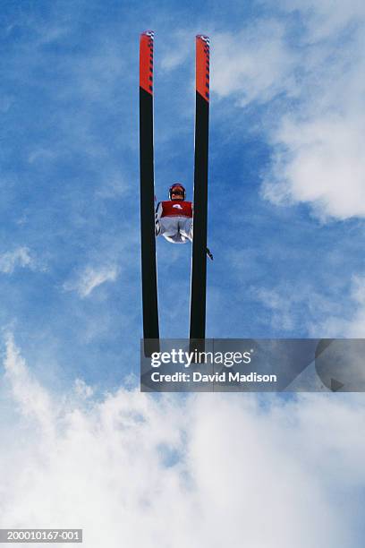 ski jumper flying through the sky, view from below - salto con gli sci foto e immagini stock