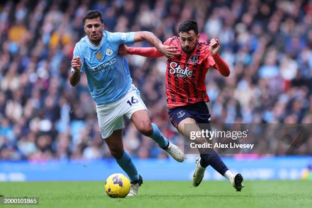Rodri of Manchester City battles for possession with Dwight McNeil of Everton during the Premier League match between Manchester City and Everton FC...