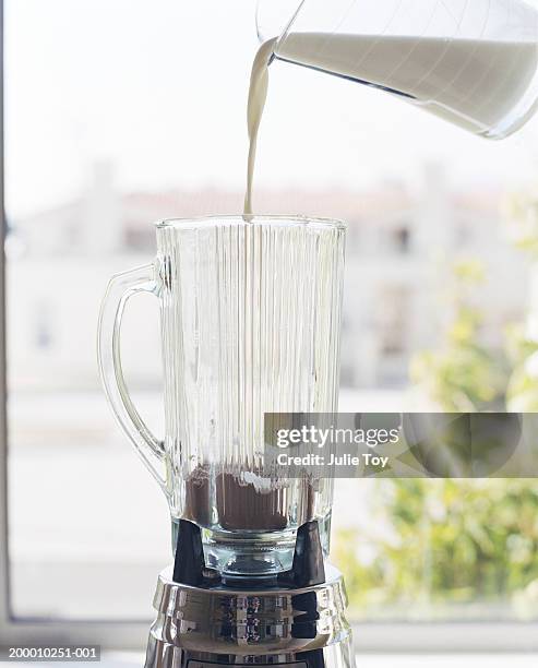 milk being poured into blender with protein powder - liquidiser stock pictures, royalty-free photos & images