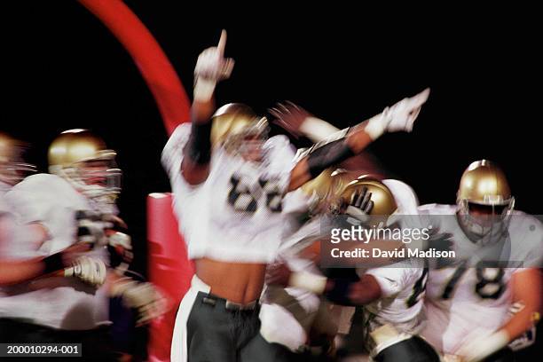 american football team celebrating touchdown (blurred motion) - scoring touchdown stock pictures, royalty-free photos & images