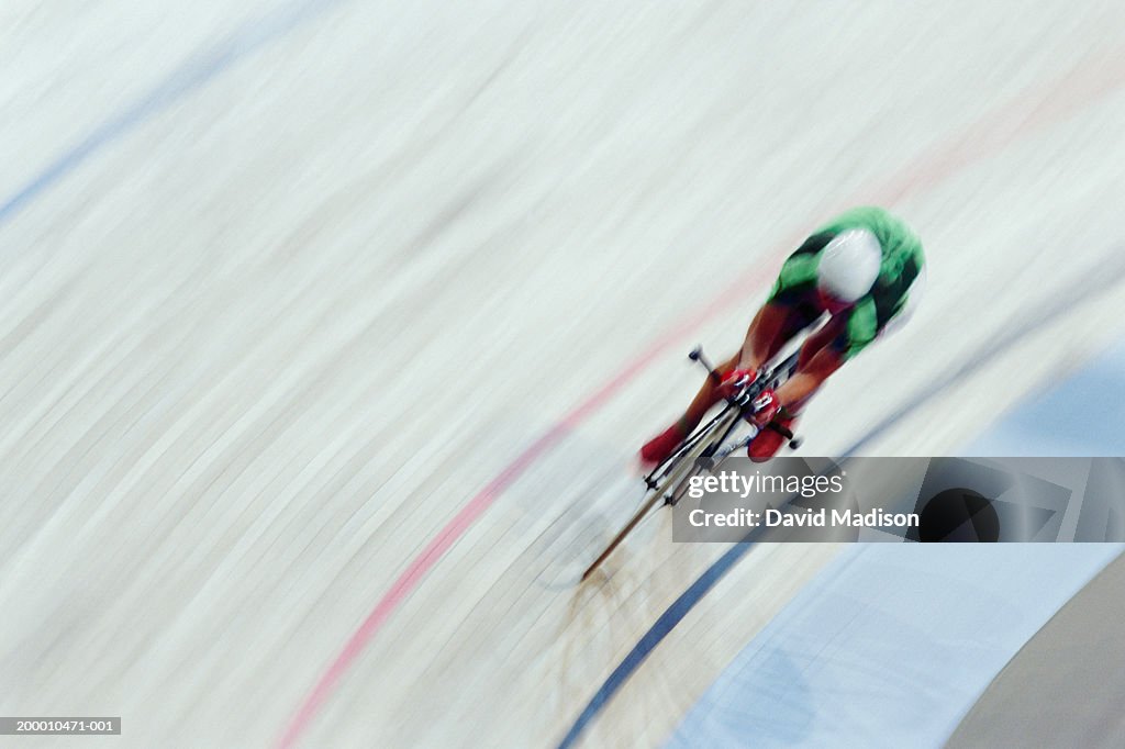 Velodrome cyclist racing, overhead view (blurred motion)