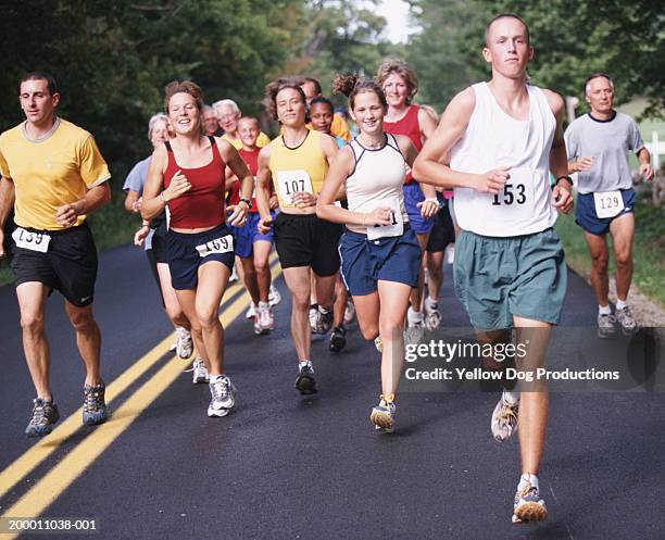 people running in road race - sports bib stock pictures, royalty-free photos & images