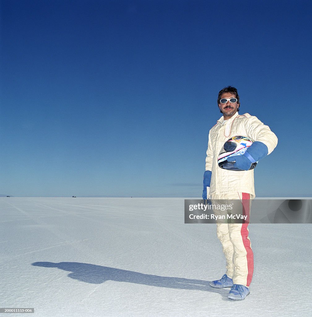 USA, Utah, Bonneville Salt Flats, racecar driver standing on raceway