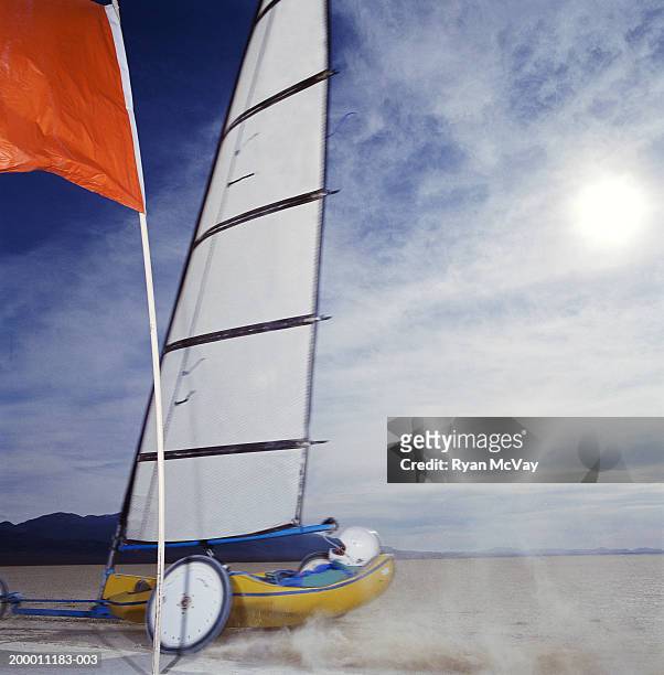 man land yachting on dry lake bed, side view, smith creek, nevada, usa - zeilwagen stockfoto's en -beelden