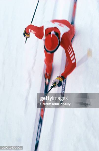 male cross country ski racer, overhead view (blurred motion) - cross country skiing stock pictures, royalty-free photos & images