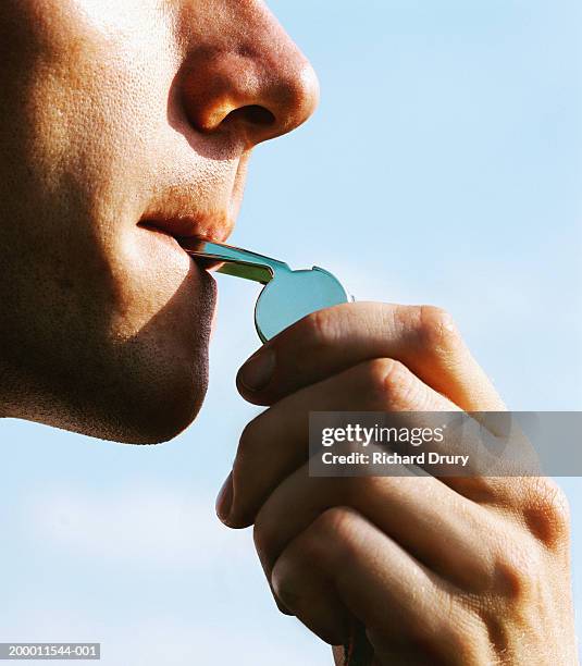 man blowing whistle, close-up - pfeife stock-fotos und bilder