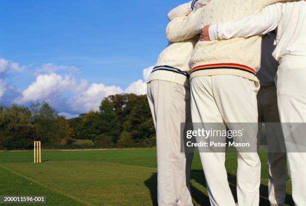 cricket team in huddle - huddling stock pictures, royalty-free photos & images