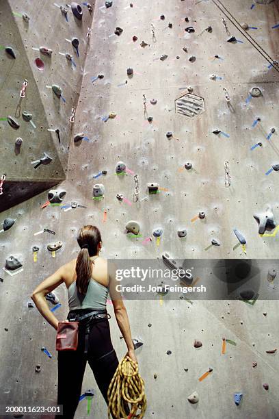 woman looking at rock climbing wall - climbing wall stock pictures, royalty-free photos & images