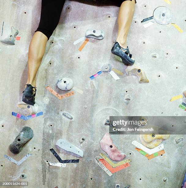 woman climbing rock climbing wall, low section - climbing wall stock pictures, royalty-free photos & images