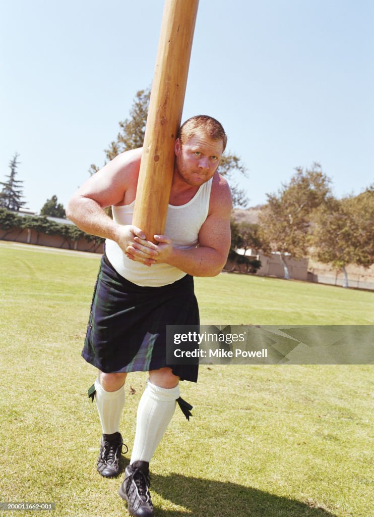 Highland Games, competitor tossing caber