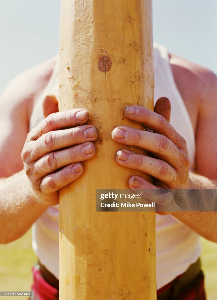 Highland Games, competitor measuring up caber
