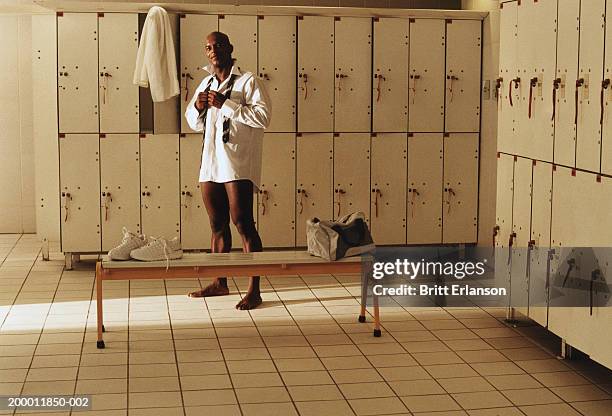 businessman changing in locker room, portrait - mens changing room stock pictures, royalty-free photos & images