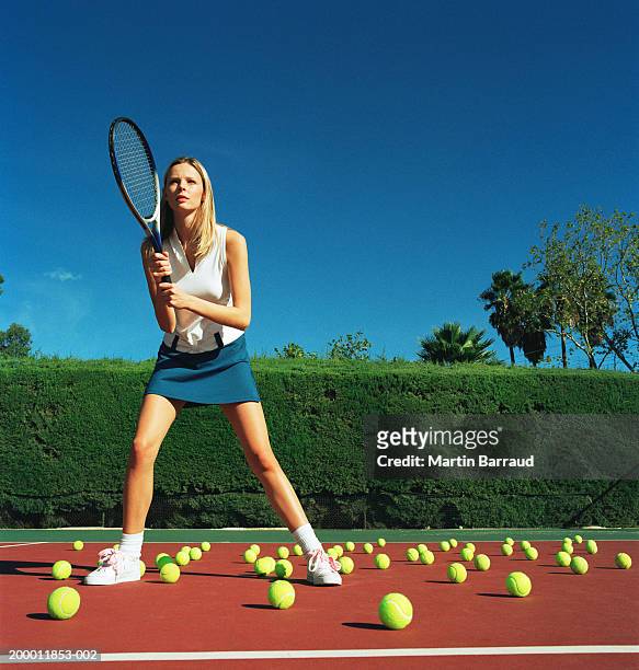 female tennis player surrounded by tennis balls on court - tennis woman stockfoto's en -beelden