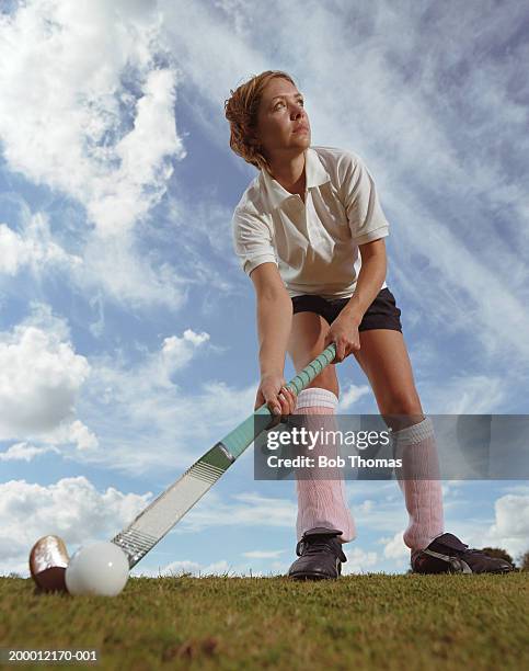 female hockey player on pitch, low angle view - hockey equipment stockfoto's en -beelden
