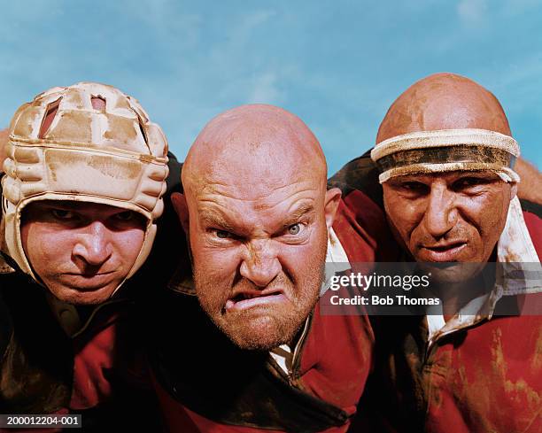 three rugby players, man in centre pulling face, portrait, close-up - rugby portraits stock-fotos und bilder