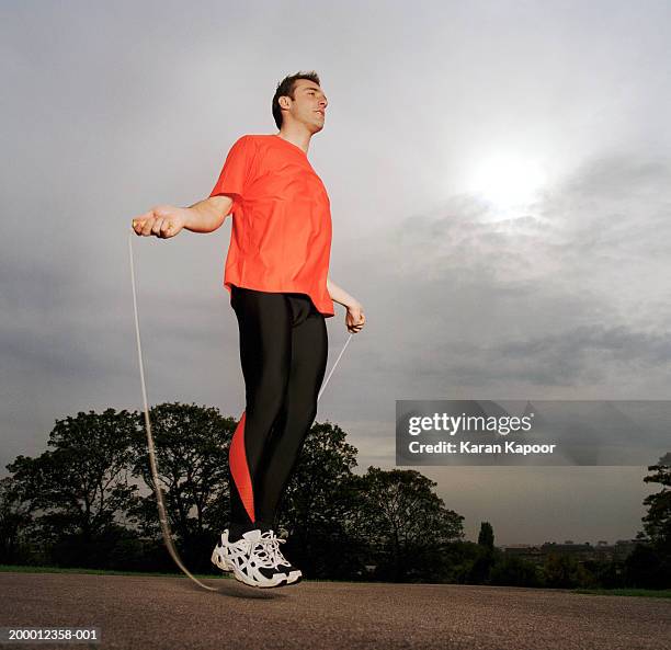 man skipping outdoors, low angle view - person skipping stock pictures, royalty-free photos & images