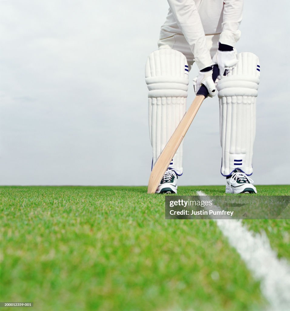 Cricket batsman preparing to bat, low section