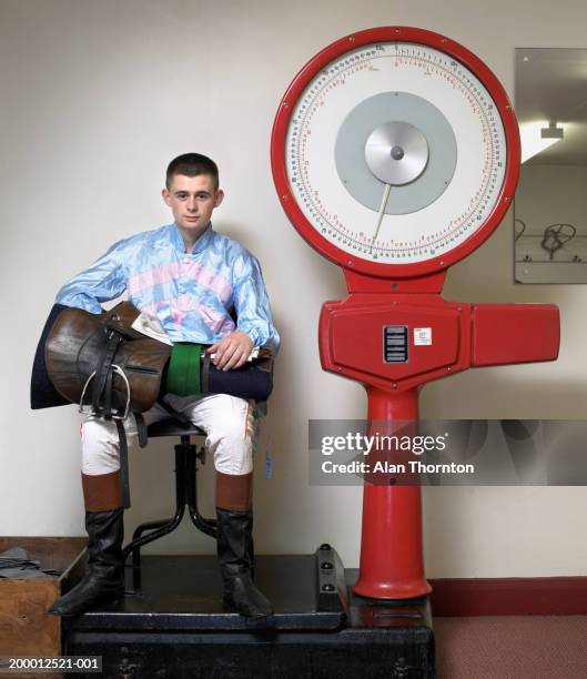 teenage jockey (16-18) with  equipment weighing in, portrait - racing silks fotografías e imágenes de stock