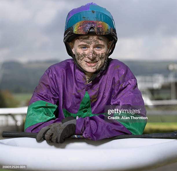 teenage jockey (16-18) with dirty face, portrait - jockey clothing stock pictures, royalty-free photos & images