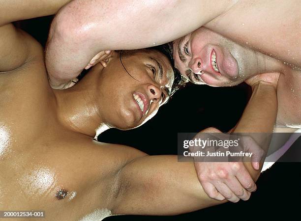 two young men wresting, low angle view - mixed wrestling imagens e fotografias de stock