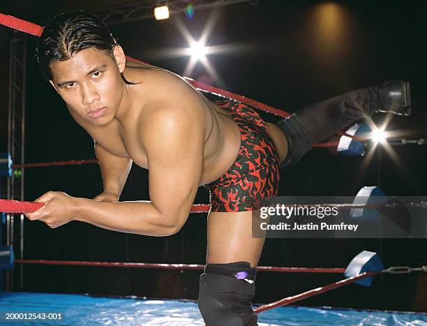 young male wrestler climbing into ring, portrait - mixed wrestling imagens e fotografias de stock