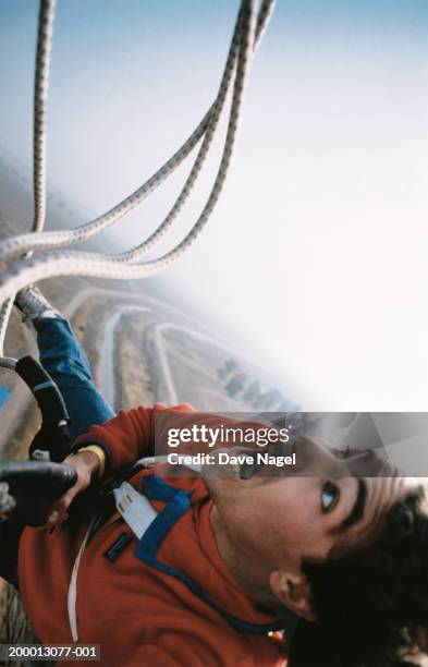 young man bungee jumping from hot air balloon, close-up - bunjee jumping stock-fotos und bilder