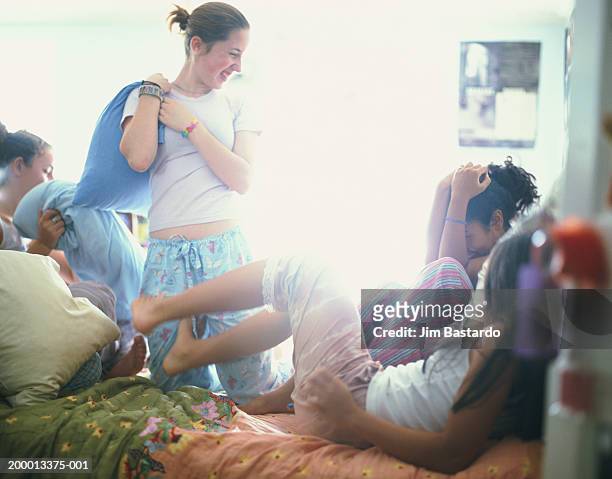 teenage girls (12-14) having pillow fight - bare feet kneeling girl stock pictures, royalty-free photos & images