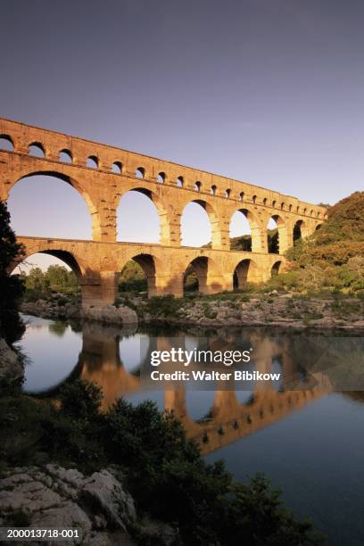 france, gard, pont du gard, sunset - pont du gard aqueduct stock pictures, royalty-free photos & images