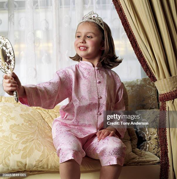 girl (4-6) wearing tiara, looking in hand mirror - silver spoon in mouth stock pictures, royalty-free photos & images