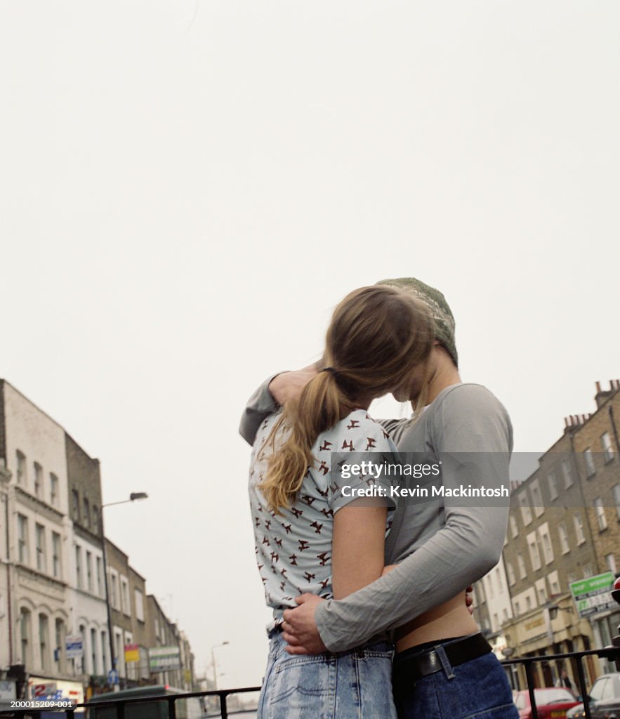 Young couple kissing on street