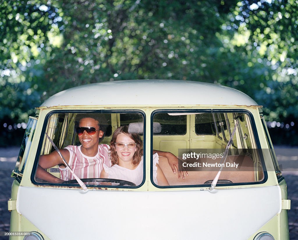 Young couple in camper van, view through windshield