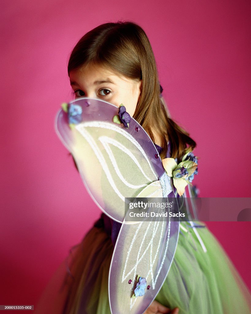 Girl (6-8) wearing fairy costume, portrait