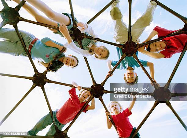 children (3-13) on climbing dome, portrait, low angle view - jungle gym stock pictures, royalty-free photos & images