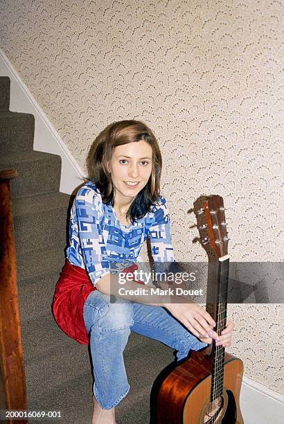 young woman sitting on stairs with guitar, portrait - barefoot landing stock pictures, royalty-free photos & images