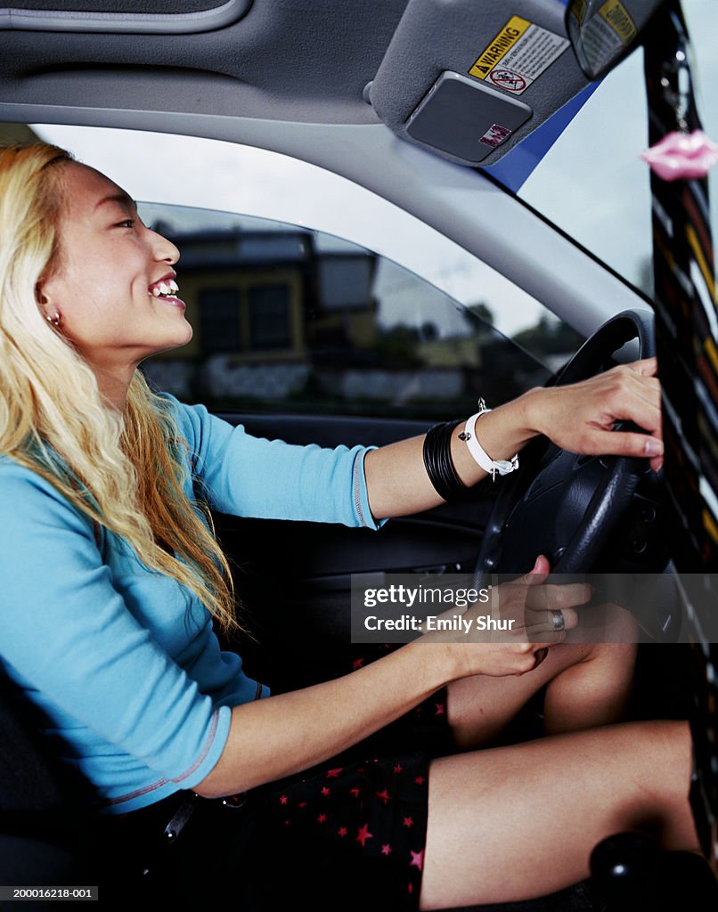 Young woman driving car, profile