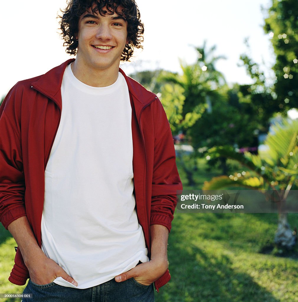 Teenage boy (14-16) smiling outdoors, portrait