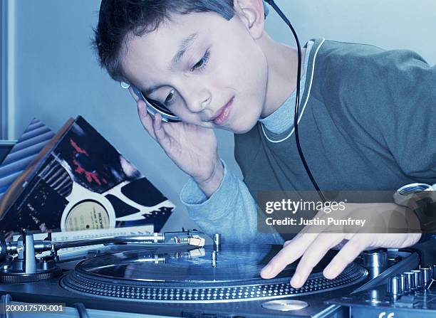 boy (12-14) mixing record on turntable, close-up - dj de club fotografías e imágenes de stock