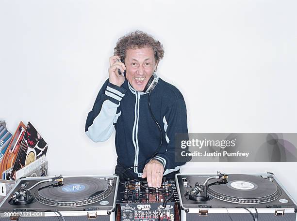 smiling man mixing records on turntable, portrait - dj portrait stock pictures, royalty-free photos & images