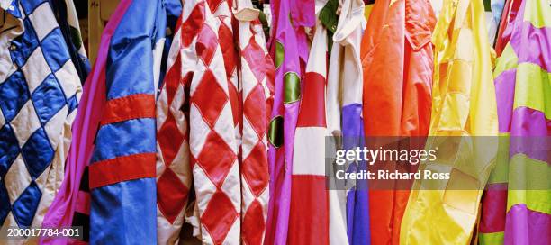 jockey's silks hanging in jockey room, close-up - jockeykläder bildbanksfoton och bilder