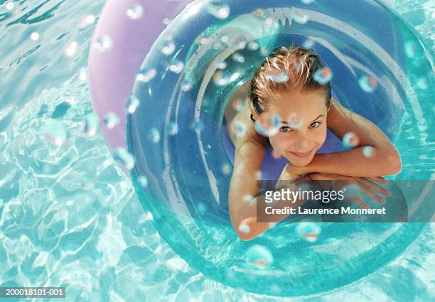 girl (8-10) on inflatable ring in pool, portrait, overhead view - day 11 stock-fotos und bilder