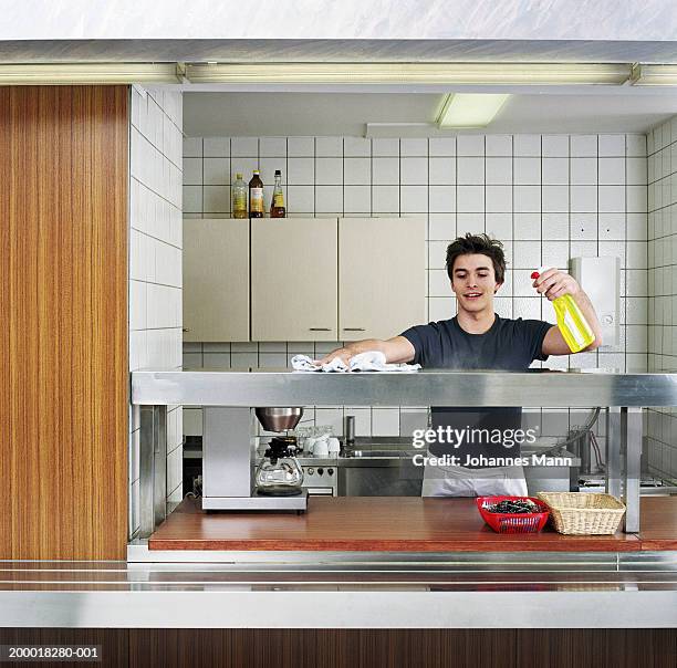 young man cleaning canteen kitchen - part time worker fotografías e imágenes de stock