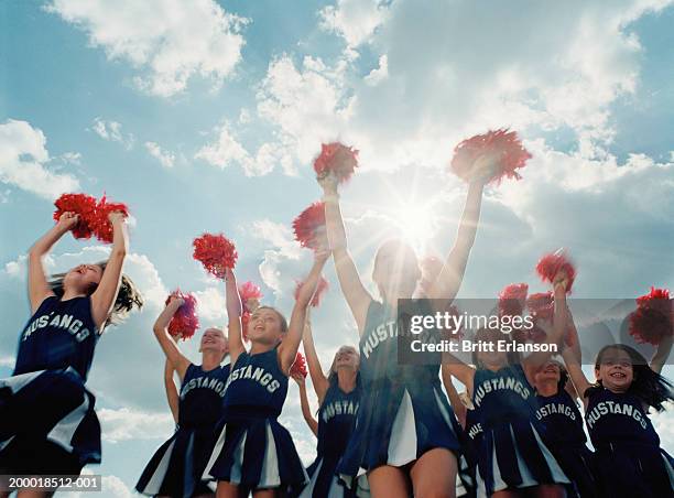 group of cheerleaders (8-10) jumping, outdoors (digital composite) - cheerleader stock-fotos und bilder