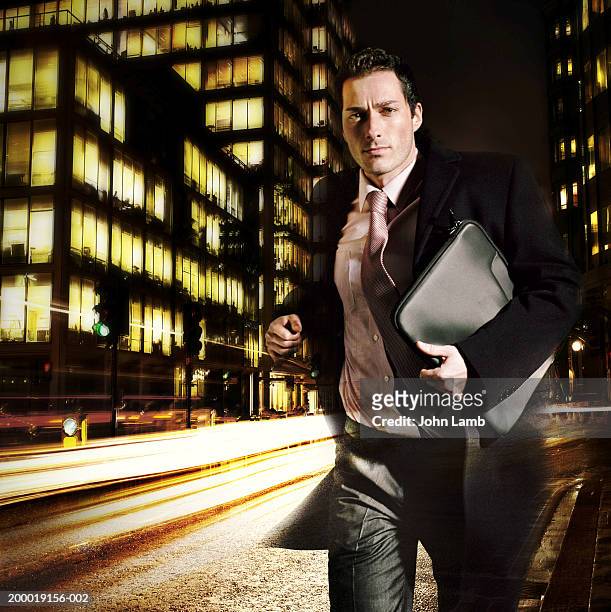 businessman running through street, night (digital composite) - solo un uomo foto e immagini stock