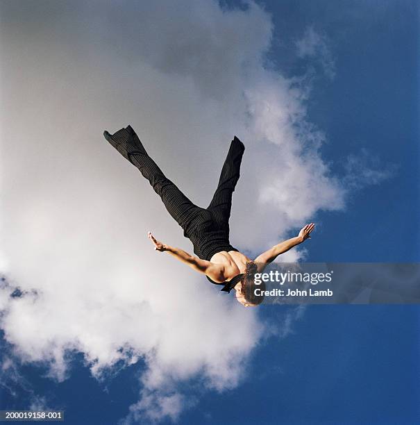 woman upside down in mid air, arms outstretched - fallen heroes stock pictures, royalty-free photos & images